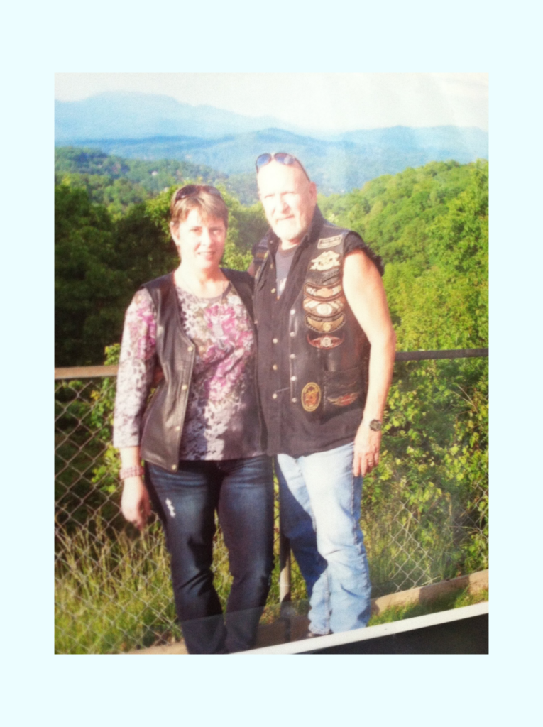 My Story 3 Chris & Teresa Brooker trip to Pigeon Forge 2014, standing on a mountain top with the beautiful landscape in the background.