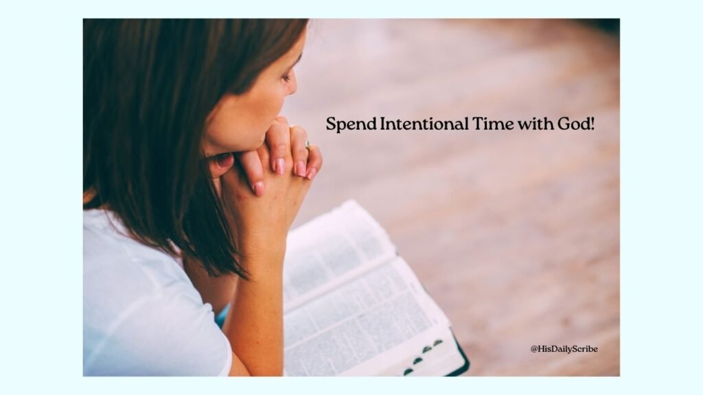 A woman in prayer with a Bible on her lap and hand folded. Spend intentional time with God.