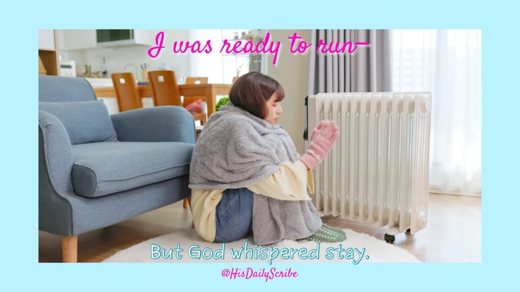 Young woman bundled in blankets sitting by a space heater in a cozy home environment.